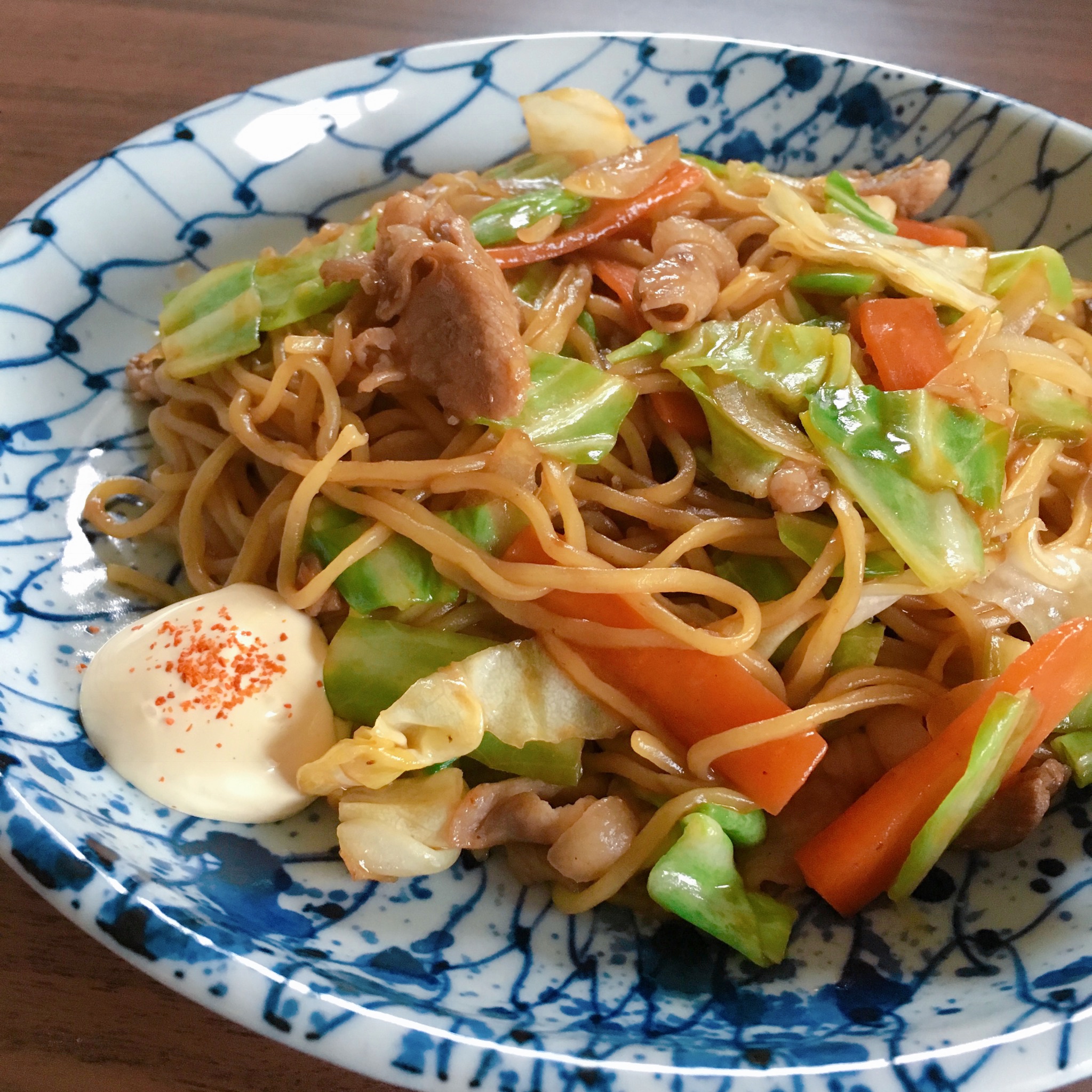 Vegetables, pork, and Chinese noodles are stir-fried and mixed with a fragrant sauce.