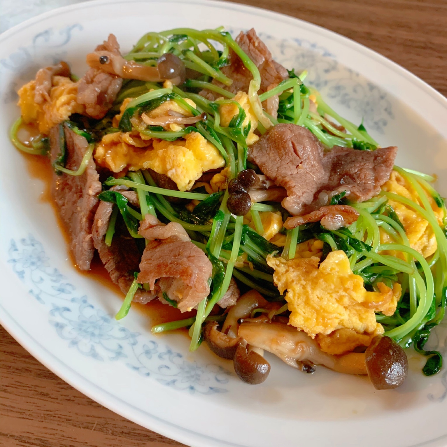 Stir-fried beef and pea sprouts and seasoned with oyster sauce.