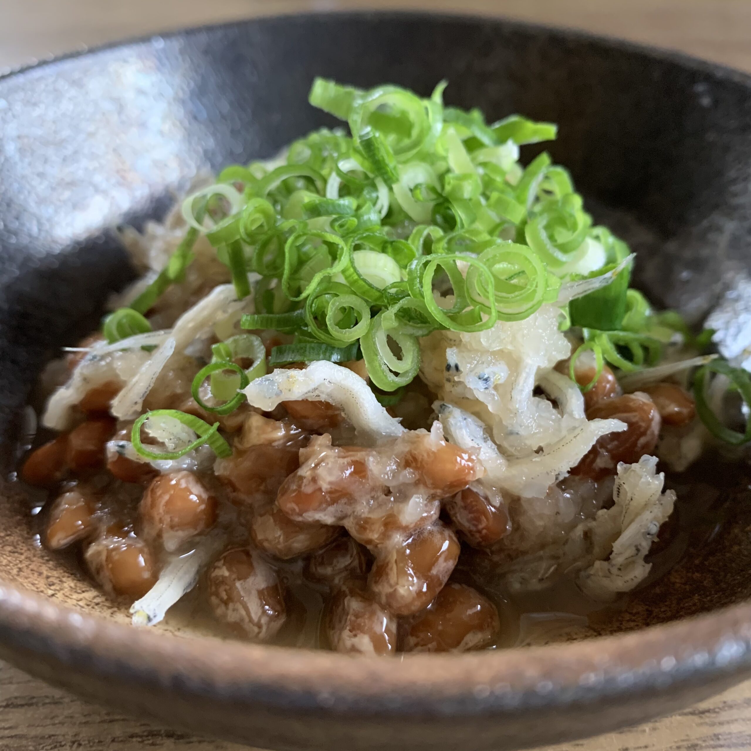 A dish of natto mixed with grated daikon radish and shirasu.