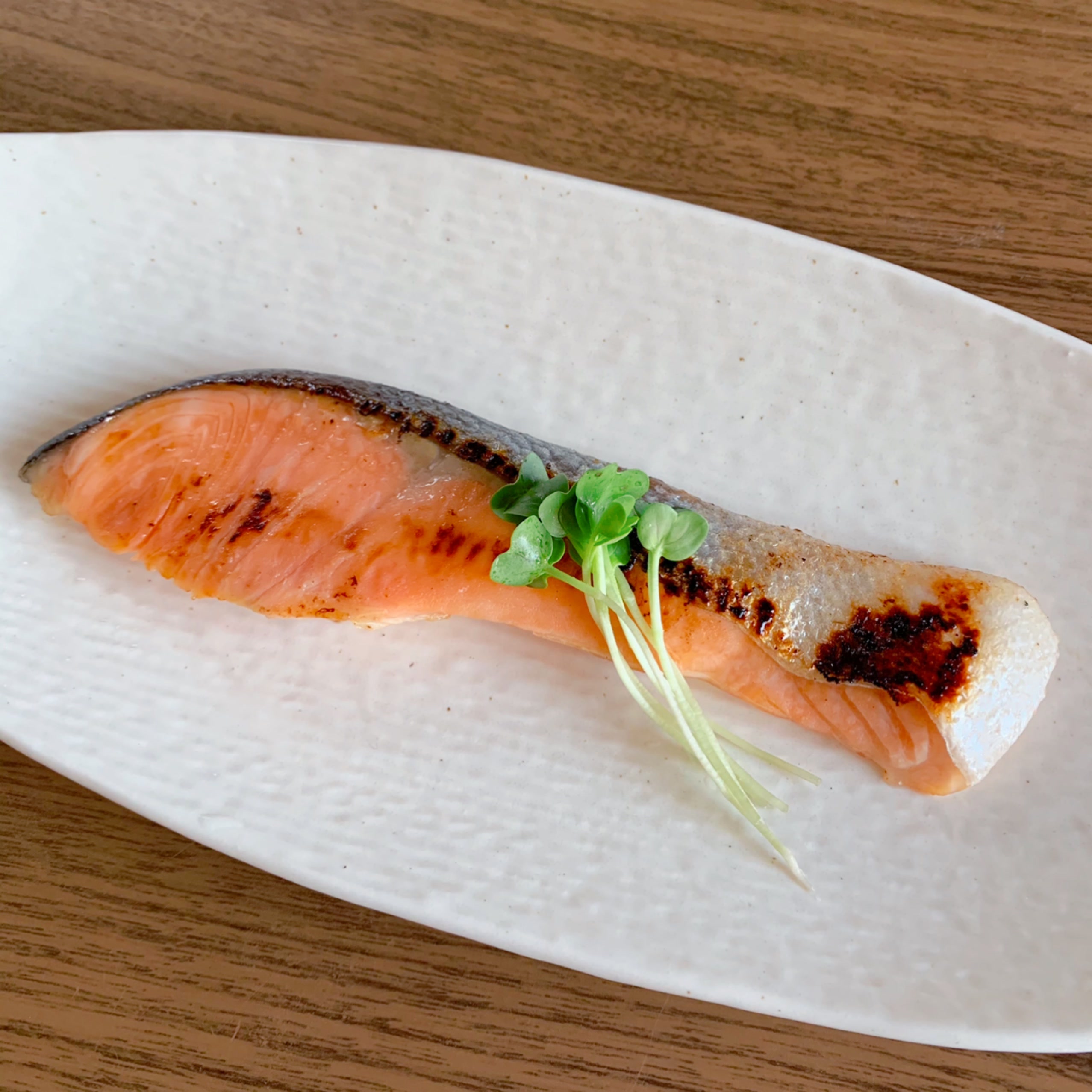 A dish of salmon marinated in shio-koji and grilled in a pan.