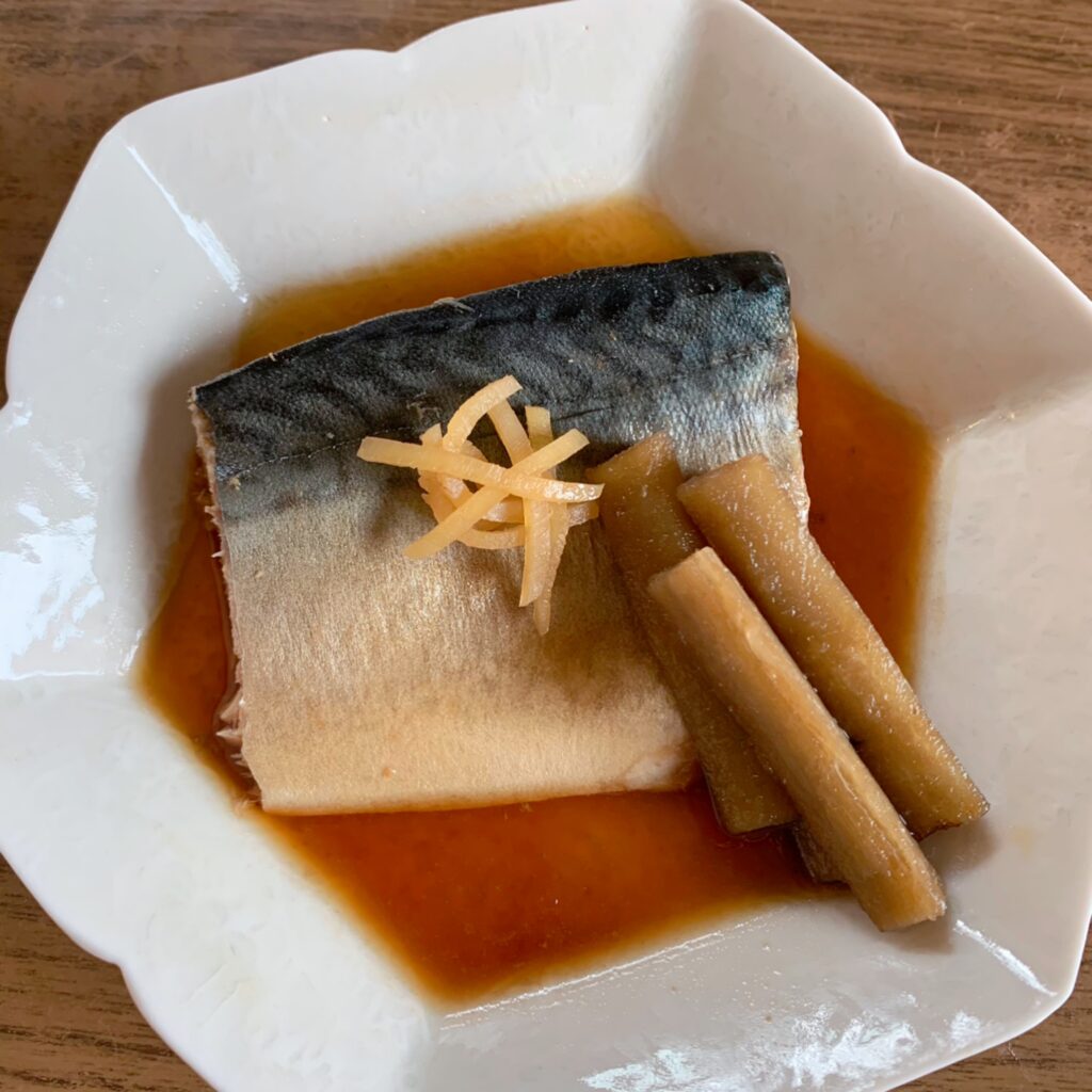 A dish of mackerel braised in soy sauce and sugar. 