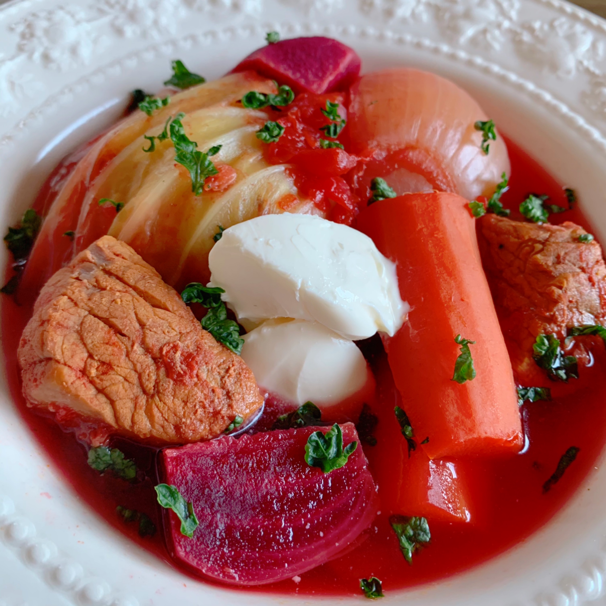 A soup made with stewed beets, cabbage, and beef and seasoned with consommé.
