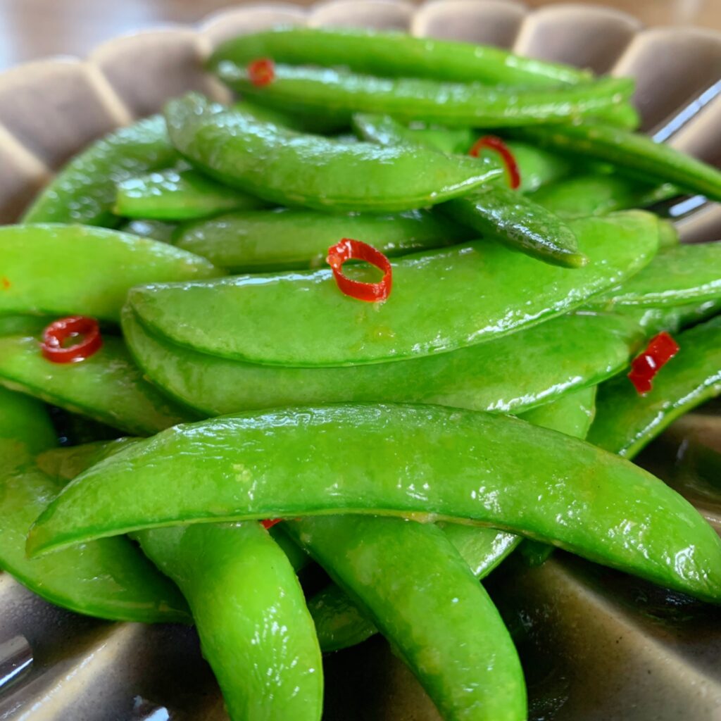 Stir-fried snap peas and seasoned with chicken broth mix. 