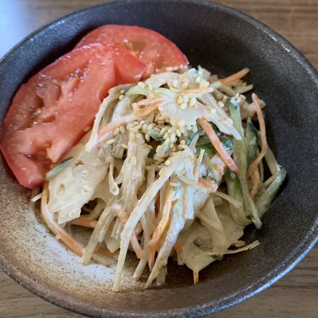 This salad is made with burdock, lotus root, carrots, and cucumbers cut into thin strips and tossed in mayonnaise. 