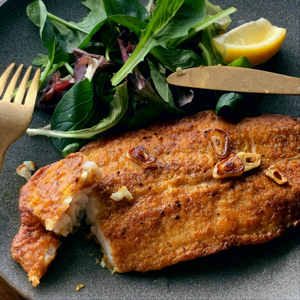 Pangasius is coated with curry powder and sautéed in butter.  