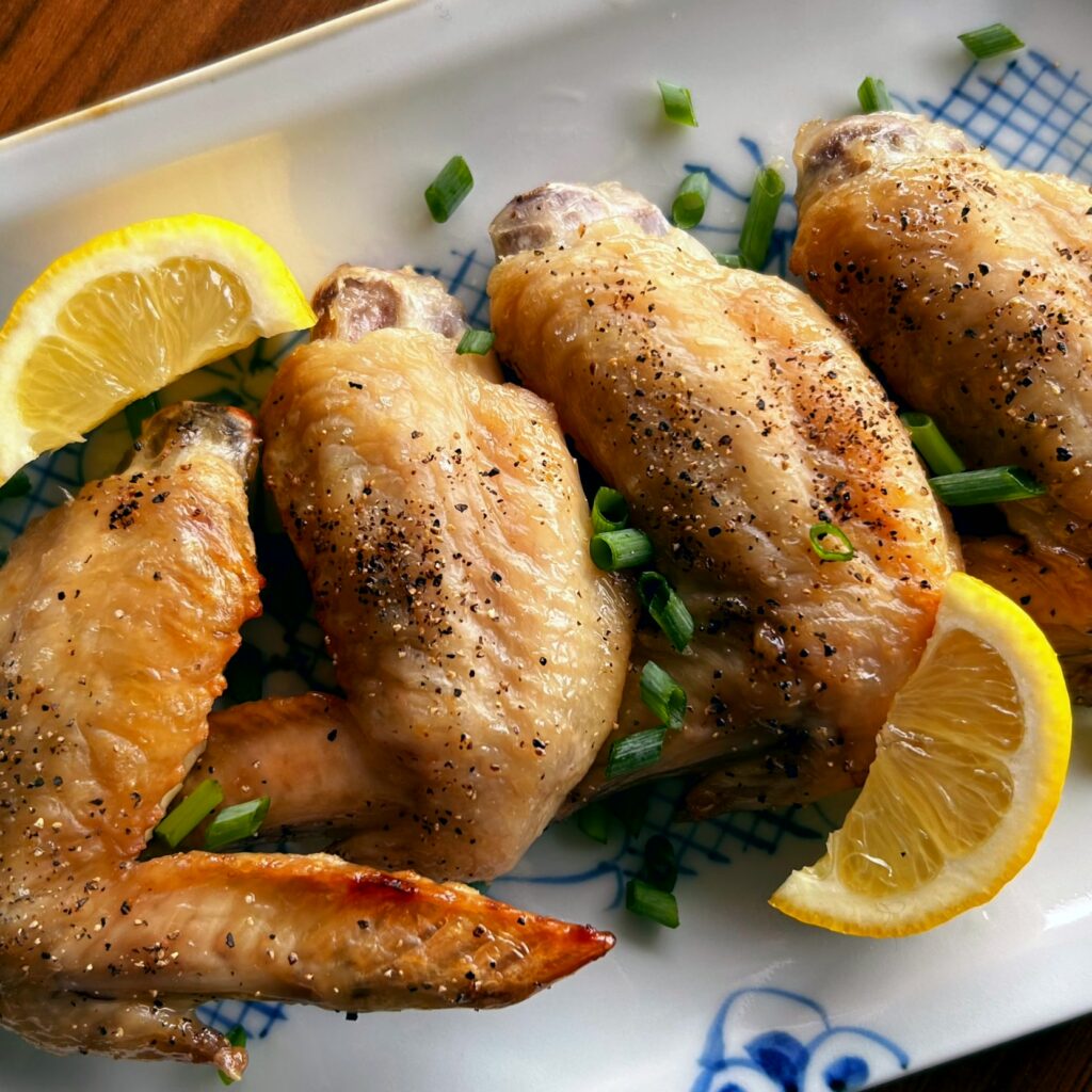 This is a very simple dish that just requires rubbing salt and pepper on chicken wings and grilling them. 